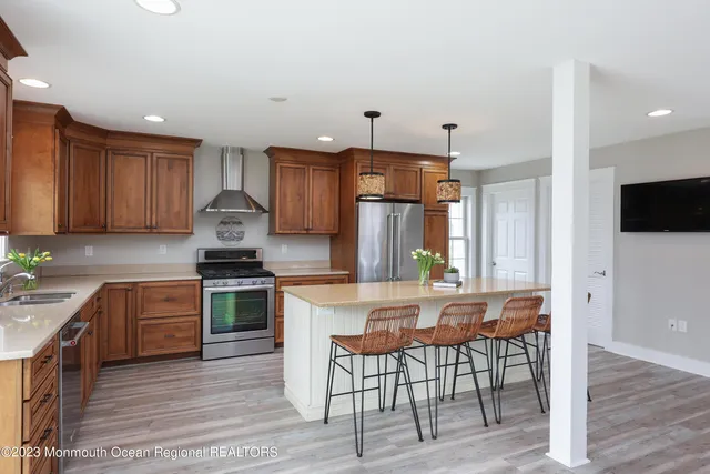a kitchen with granite countertop wooden floors and stainless steel appliances