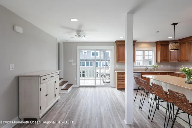 a view of a kitchen with furniture and wooden floor