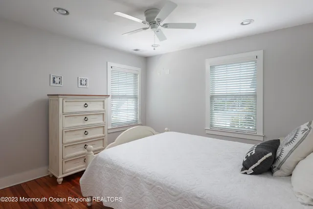 a bedroom with a bed a dresser and a window