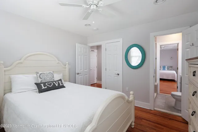 a bedroom with a large bed and a mirror