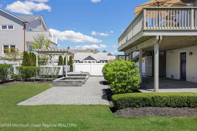 a view of a house with a yard and pathway