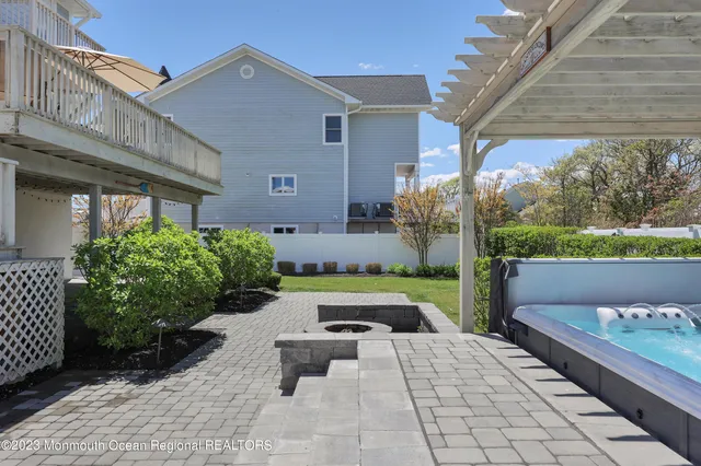 a view of a patio with a table and chairs under an umbrella