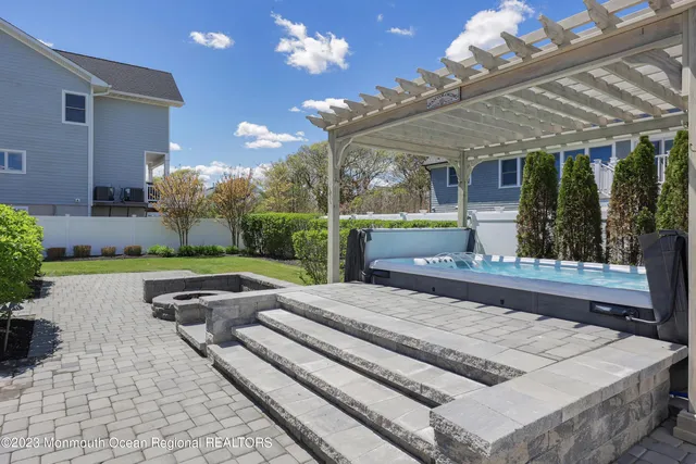 a view of a wooden bench next to a yard