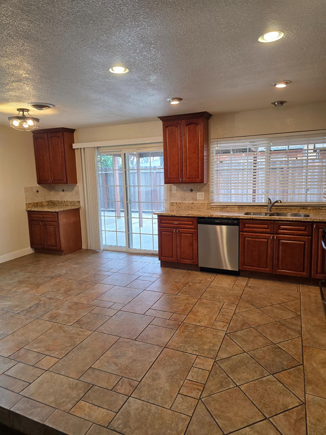 1624 Falmouth Way Modesto, CA 95355 - Photo 11 of 26 a large kitchen with stainless steel appliances granite countertop a sink and cabinets