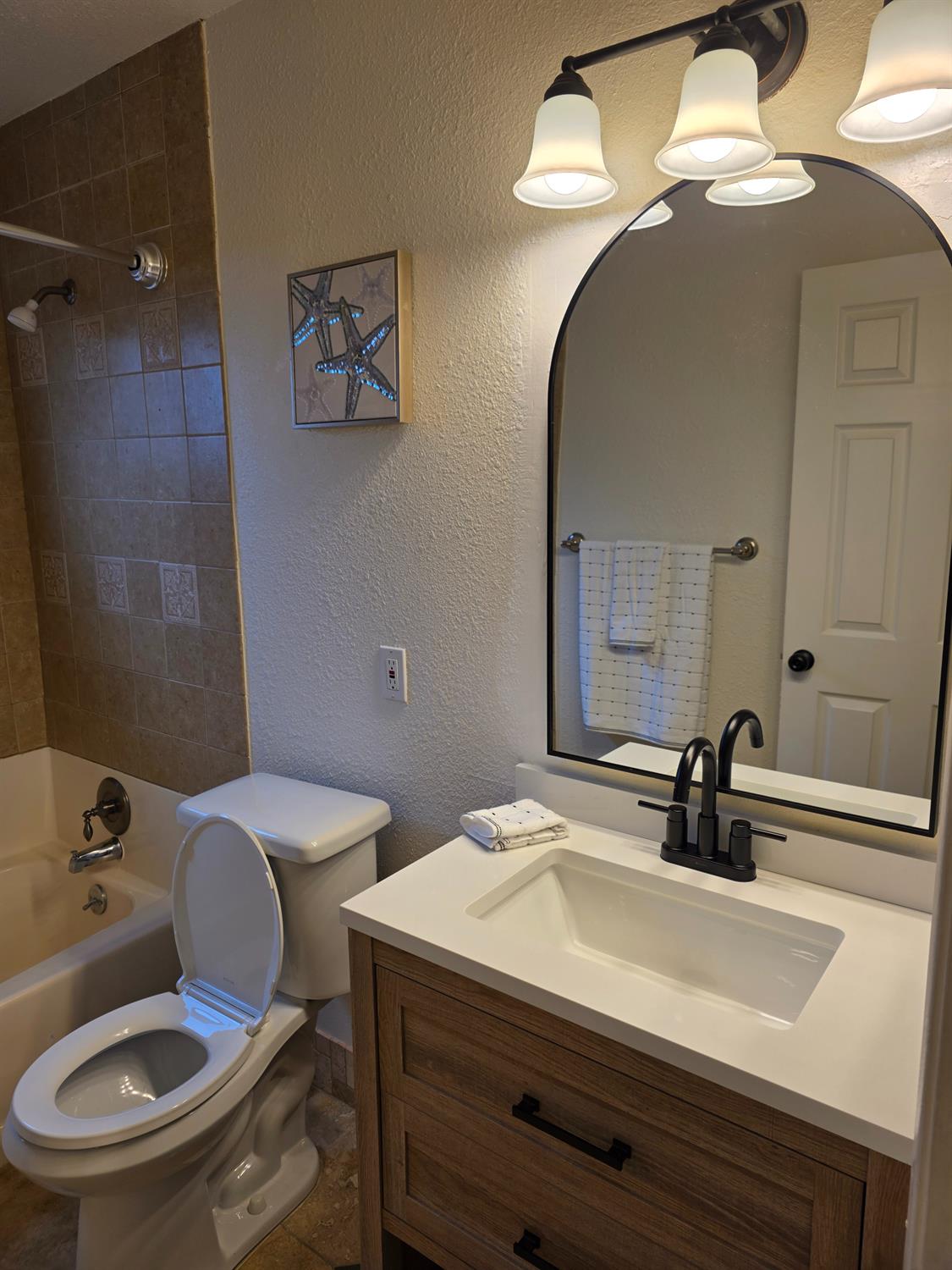 1624 Falmouth Way Modesto, CA 95355 - Photo 21 of 26 a bathroom with a toilet a sink and mirror