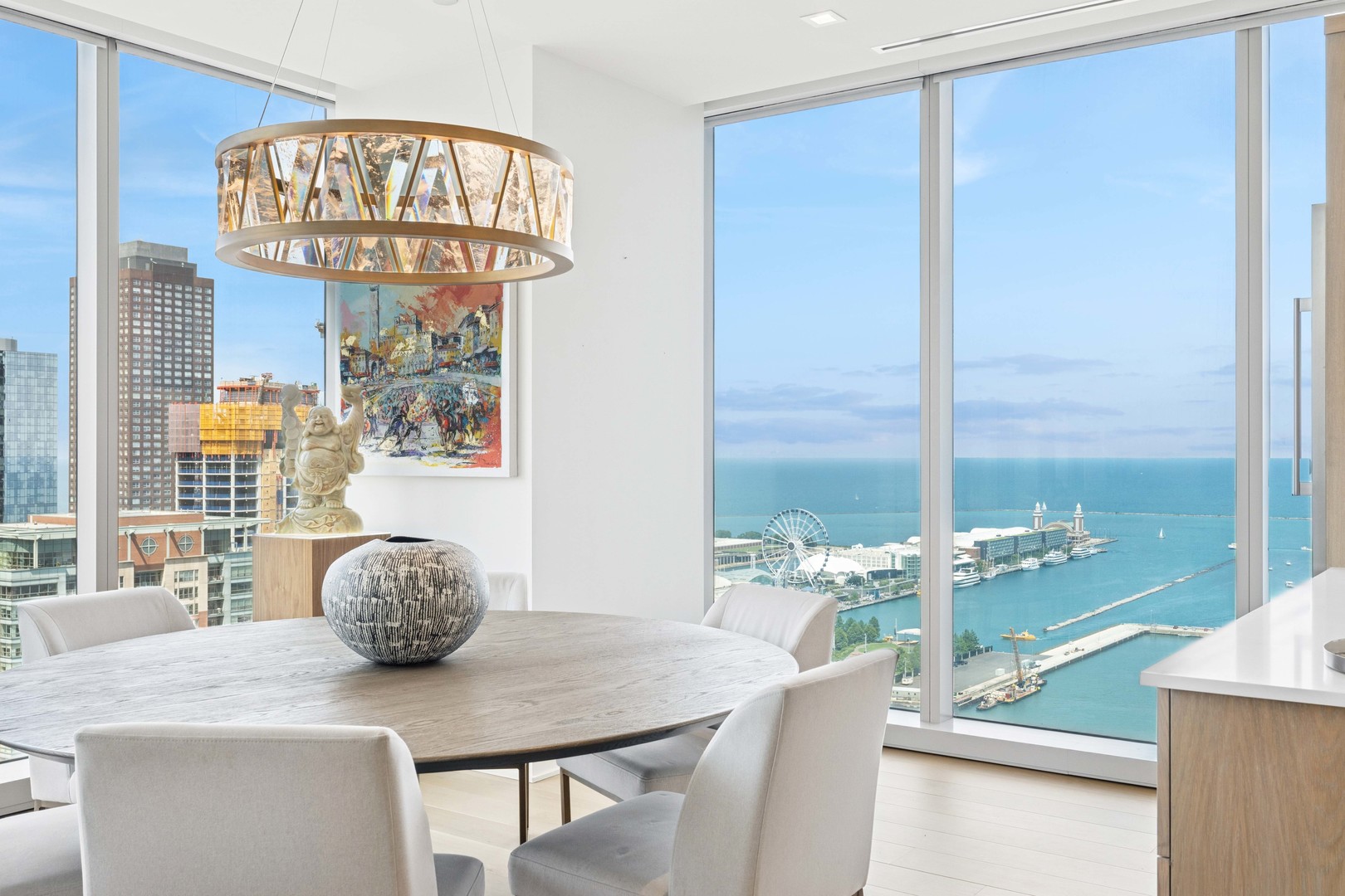 363 East Wacker Drive, Unit 2606 Chicago, IL 60601 - Photo 12 of 68 a view of a dining room with furniture a chandelier and wooden floor