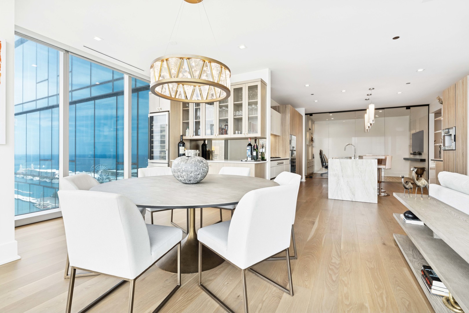 363 East Wacker Drive, Unit 2606 Chicago, IL 60601 - Photo 15 of 68 a view of a dining room with furniture wooden floor and a chandelier