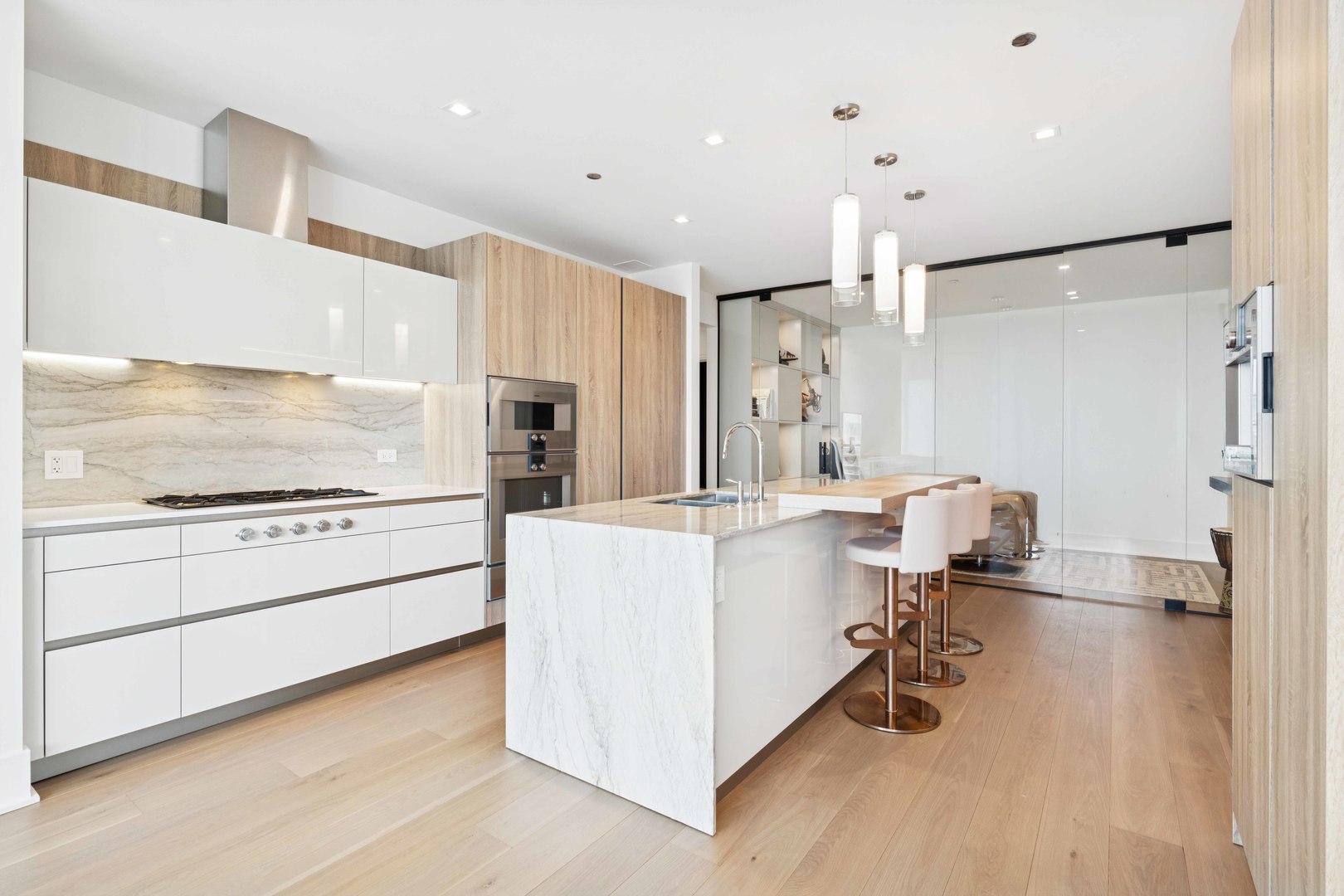 363 East Wacker Drive, Unit 2606 Chicago, IL 60601 - Photo 21 of 68 a kitchen with white cabinets and stainless steel appliances