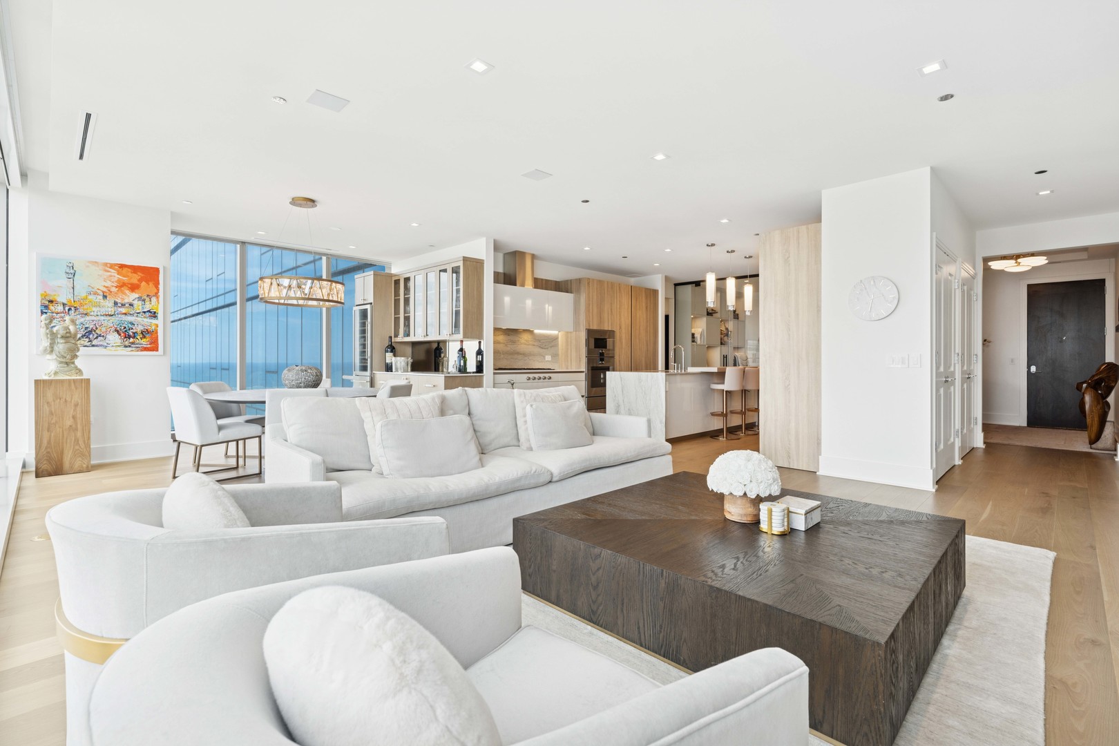 363 East Wacker Drive, Unit 2606 Chicago, IL 60601 - Photo 10 of 68 a living room with furniture and a dining table with wooden floor