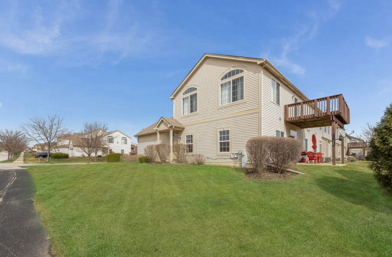 2305 Summerlin Drive Aurora, IL 60503 - Photo 20 of 22 a front view of a house with a yard and garage