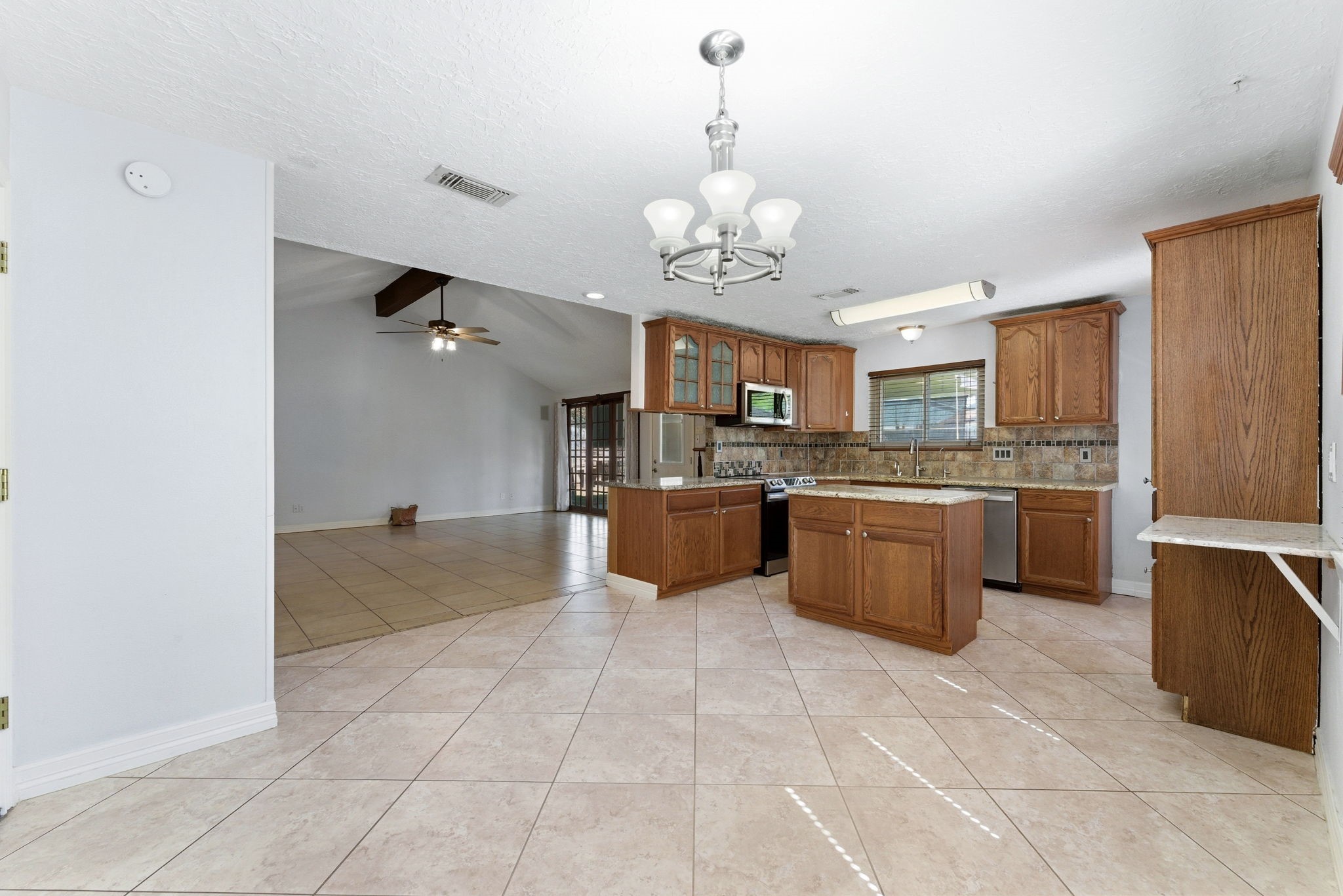 21514 Slippery Creek Lane Spring, TX 77388 - Photo 10 of 27 a large kitchen with a counter space a sink and cabinets