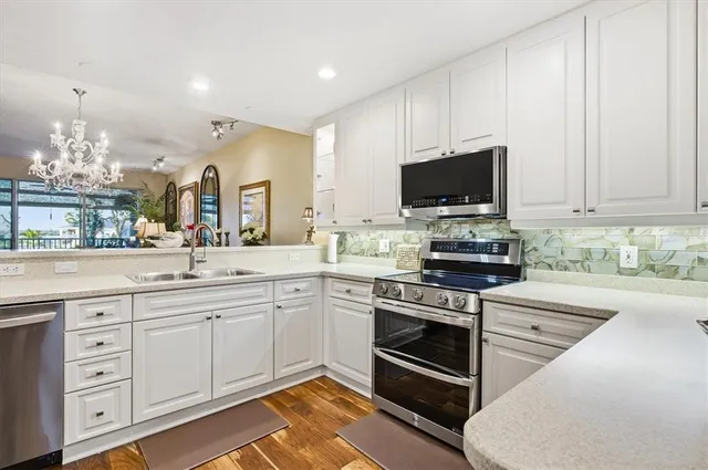 a kitchen with a sink cabinets and wooden floor