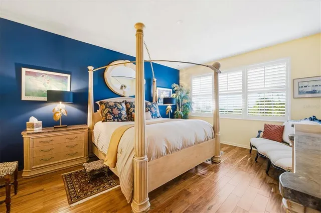 a bedroom with a bed and flat screen tv