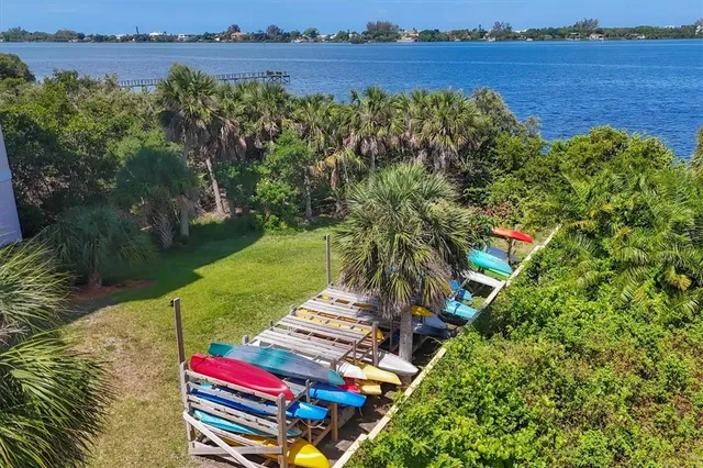 an aerial view of residential houses with outdoor space and swimming pool