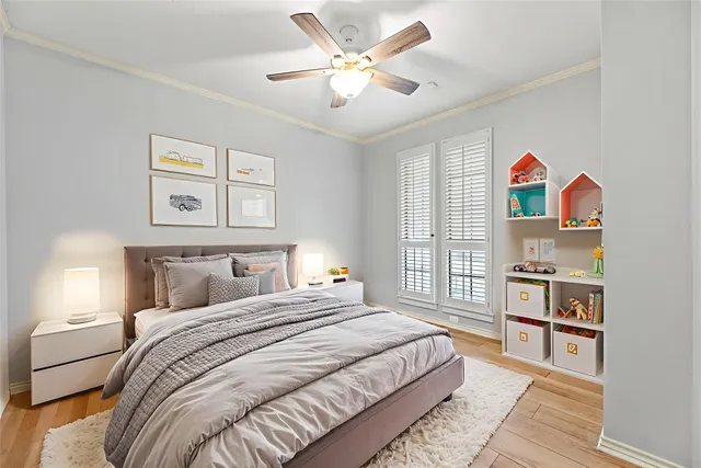 a bedroom with a bed cabinets and window