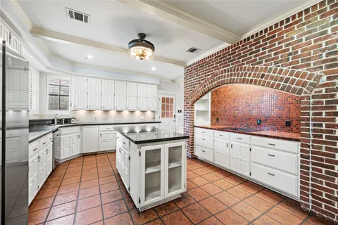 a kitchen with stainless steel appliances granite countertop a stove and cabinets