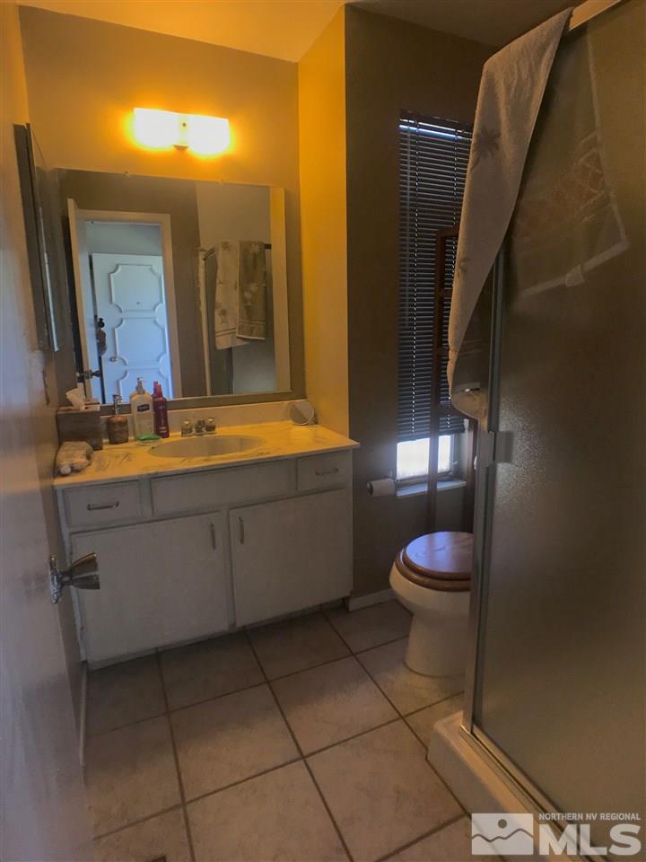 1230 Conway Lane Reno, NV 89503 - Photo 8 of 24 a bathroom with a sink a toilet and mirror