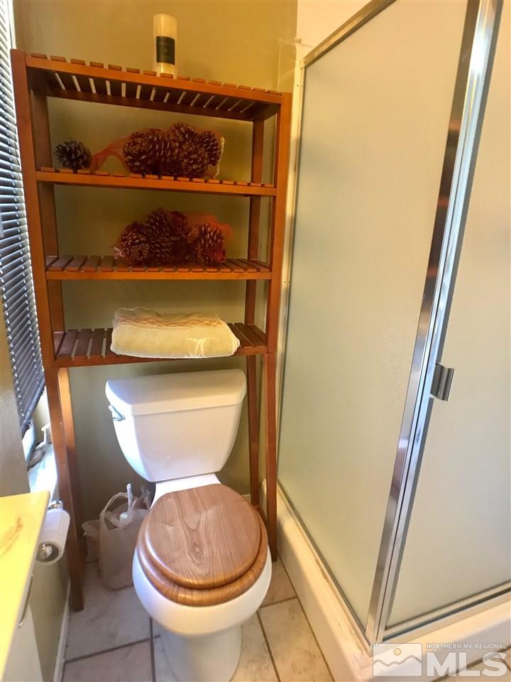 1230 Conway Lane Reno, NV 89503 - Photo 9 of 24 a bathroom with a toilet and a mirror