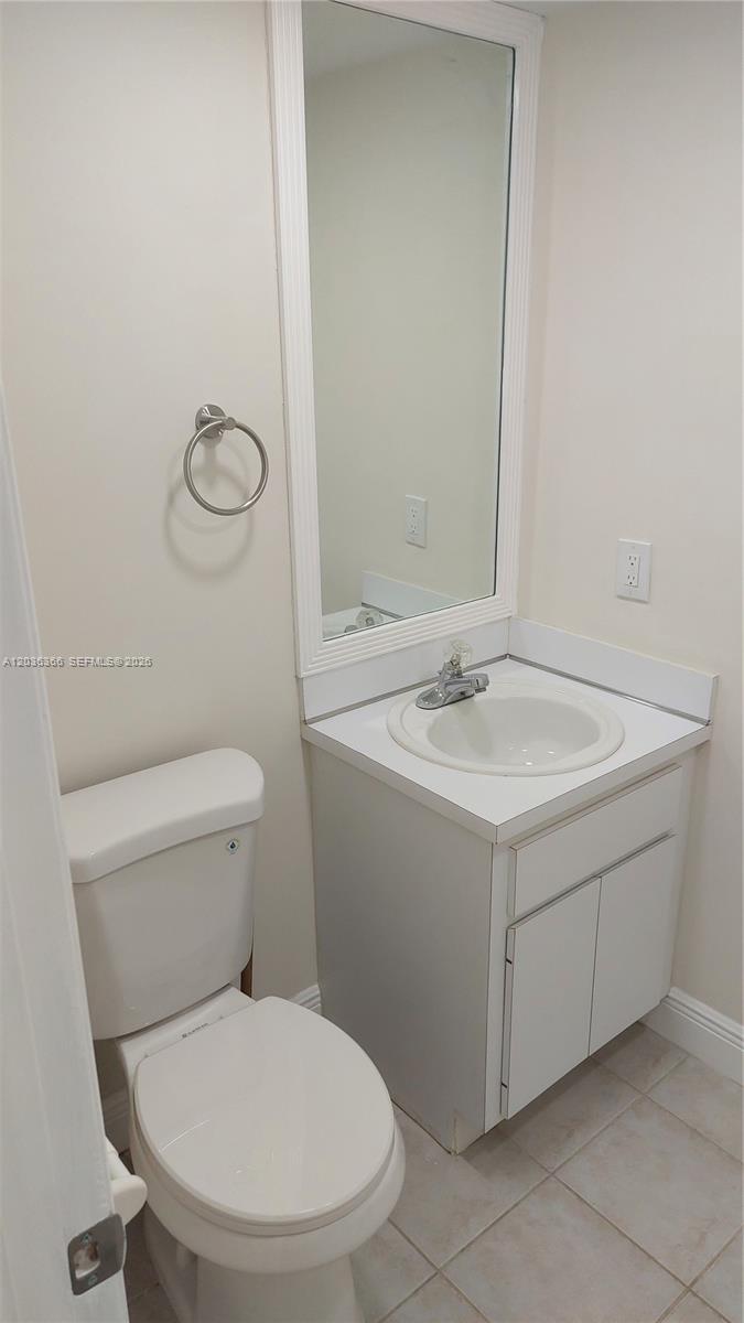 7083 Southwest 158th Court Miami, FL 33193 - Photo 6 of 22 a white toilet sitting next to a bathroom sink