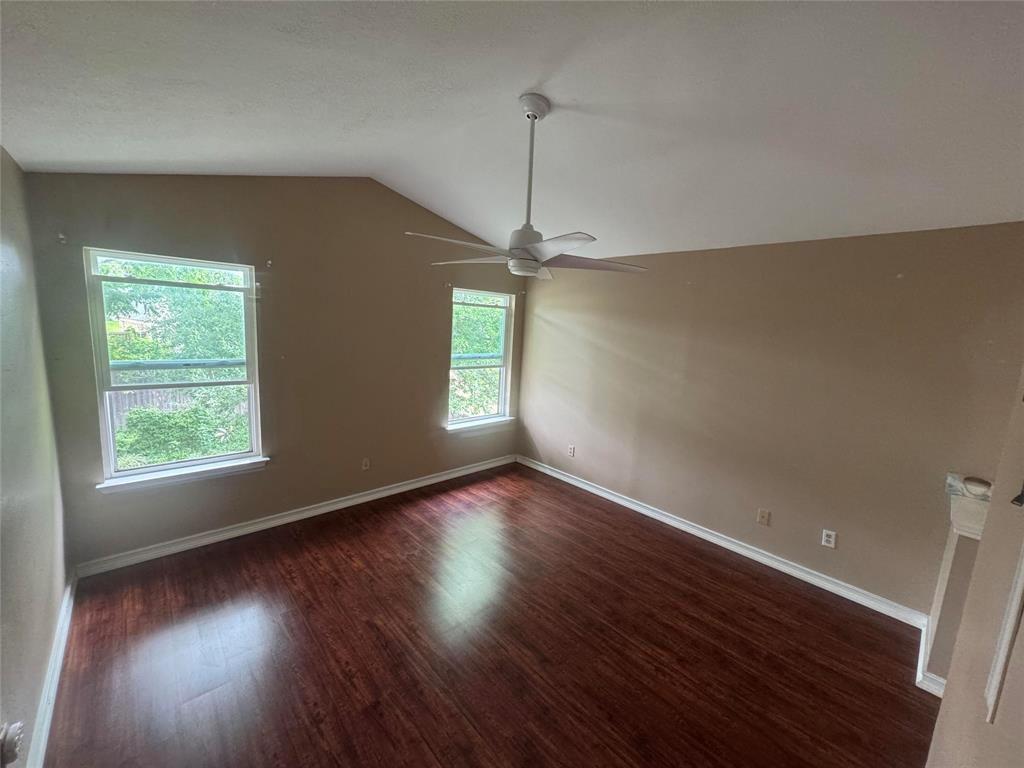 4649 Misty Ridge Drive Fort Worth, TX 76137 - Photo 3 of 25 an empty room with wooden floor and windows