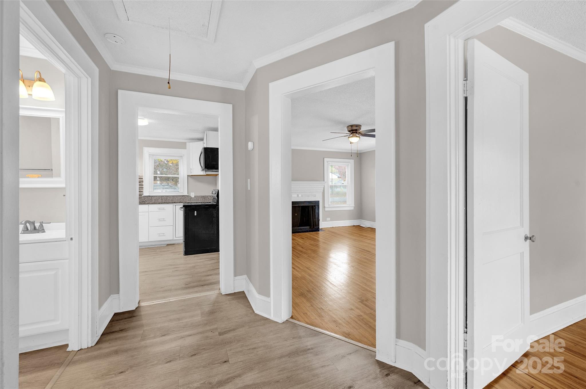 144 Robbins Street Southwest Concord, NC 28025 - Photo 22 of 29 a view of a hallway with wooden floor kitchen and a living room