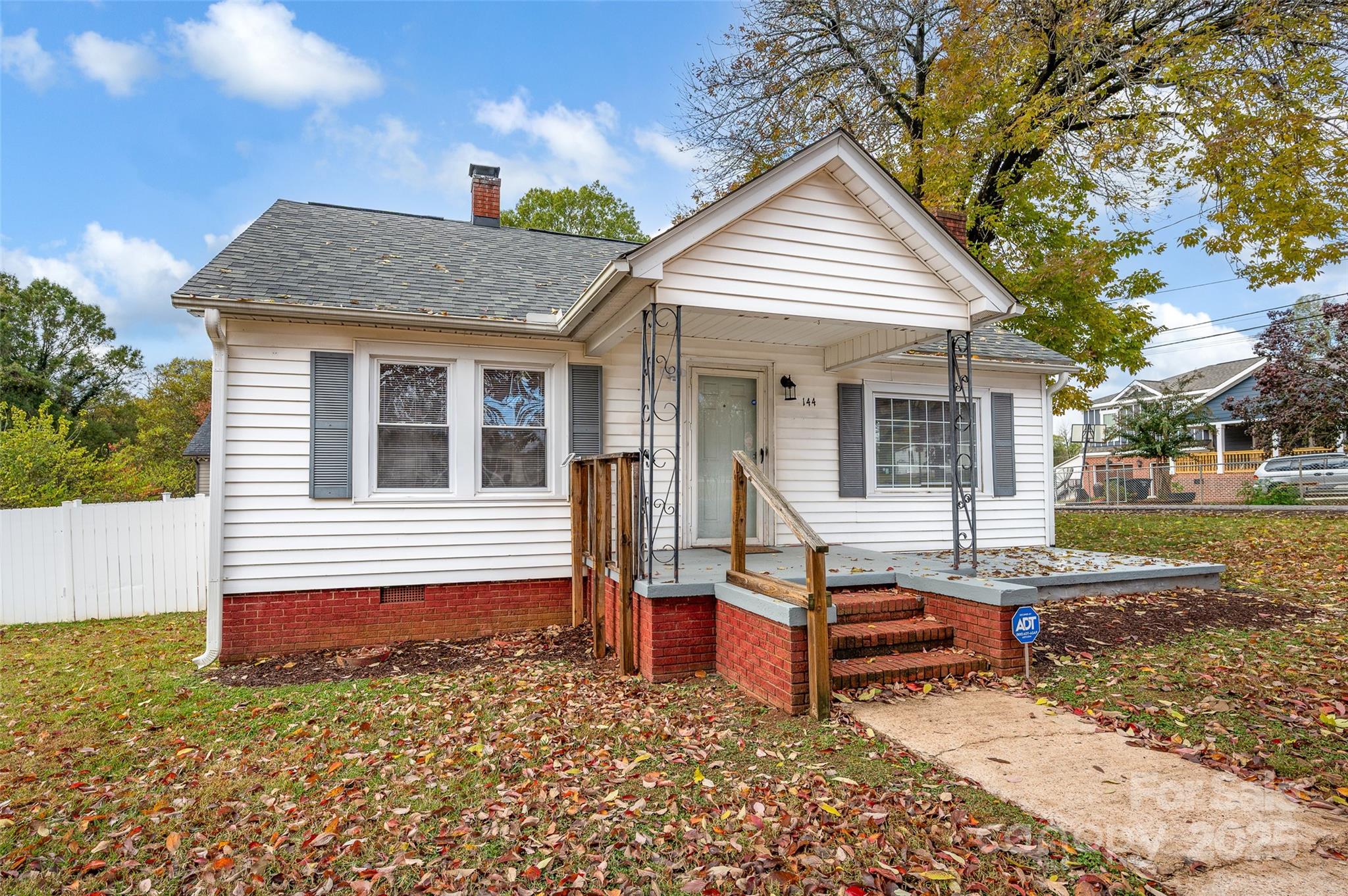144 Robbins Street Southwest Concord, NC 28025 - Photo 4 of 29 a backyard of a house with wooden deck table and chairs