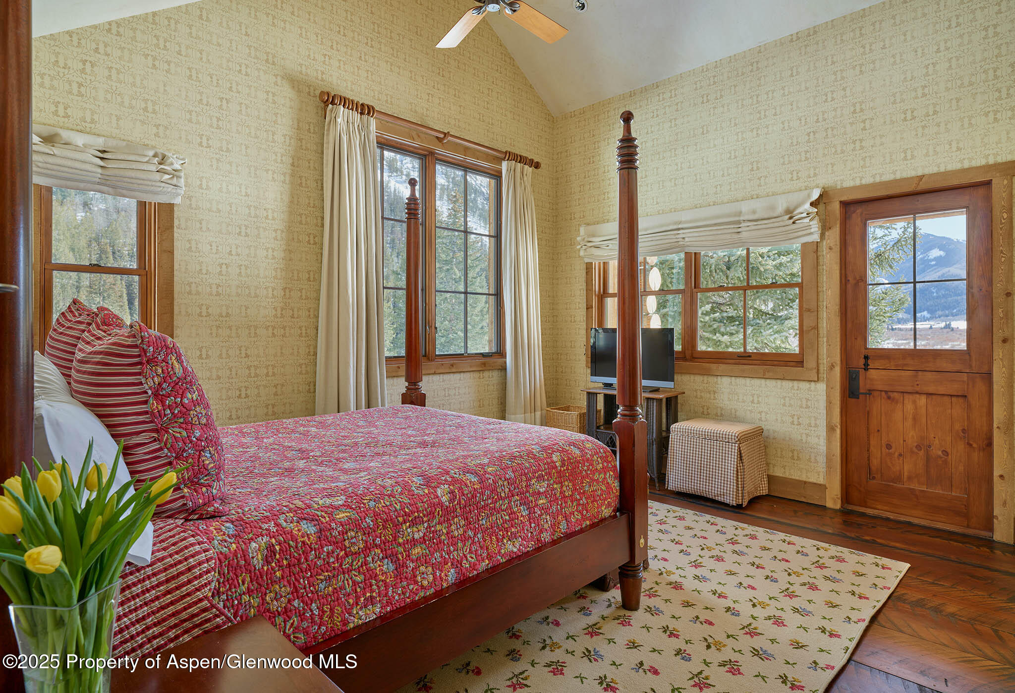 125 Rooney Circle Aspen, CO 81612 - Photo 55 of 56 a bedroom with a bed and wooden floor