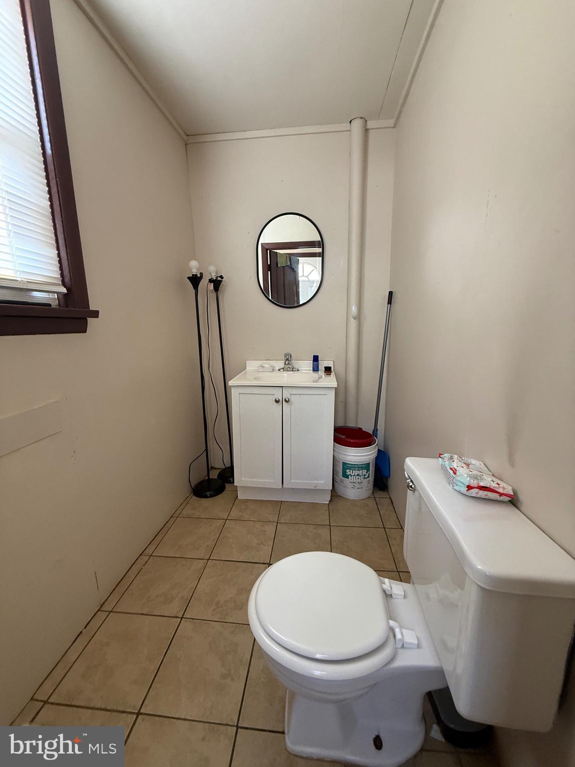 930 Spring Street Lebanon, PA 17046 - Photo 9 of 13 a bathroom with a sink mirror vanity and toilet