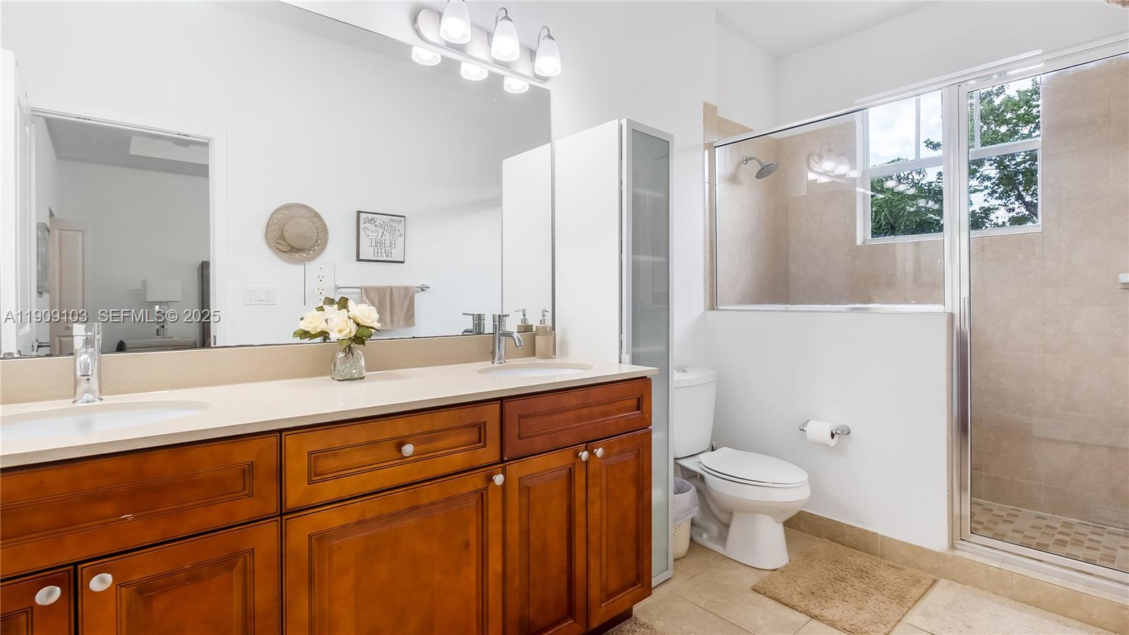 4445 Northwest 48th Terrace Tamarac, FL 33319 - Photo 11 of 19 a bathroom with a granite countertop sink a toilet a large mirror and shower