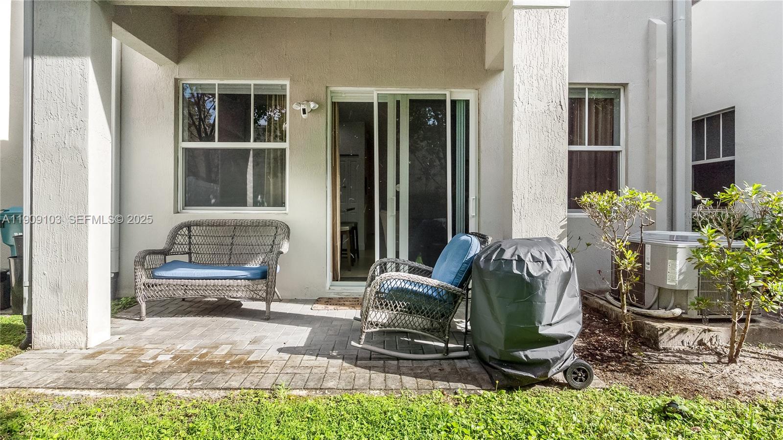 4445 Northwest 48th Terrace Tamarac, FL 33319 - Photo 18 of 19 a living room filled with furniture and a potted plant
