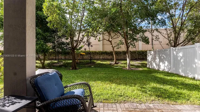 a view of backyard with seating area and green space
