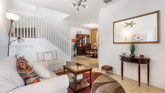 a living room with furniture and a chandelier