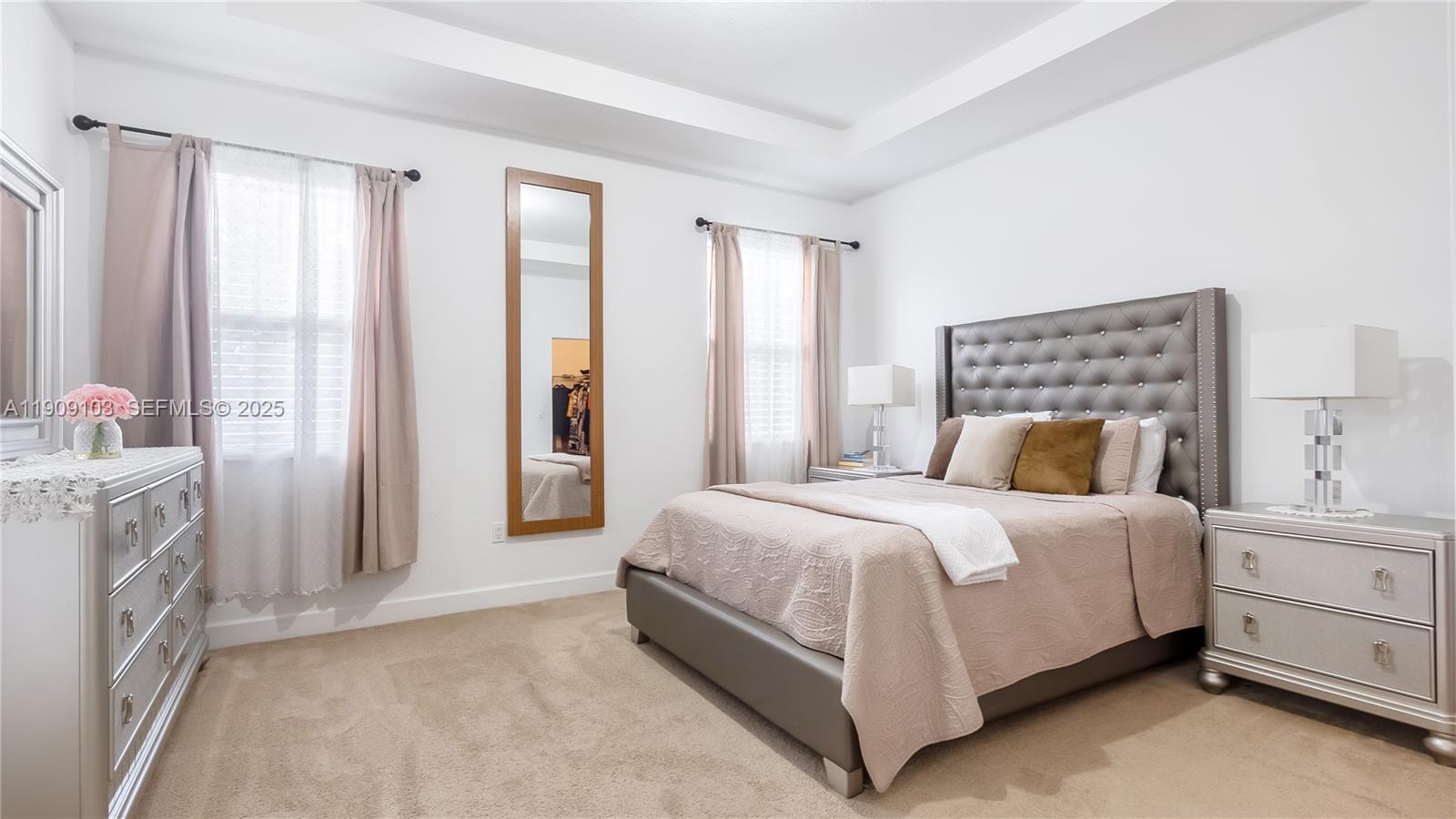 4445 Northwest 48th Terrace Tamarac, FL 33319 - Photo 9 of 19 a bedroom with a bed and a chandelier