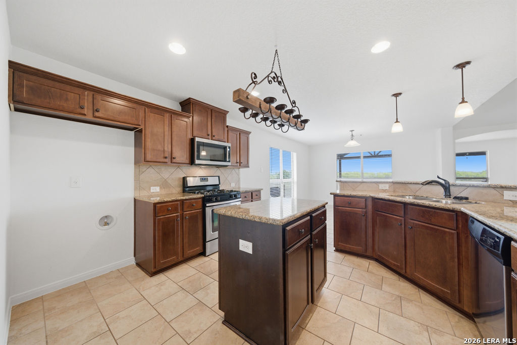 12897 La Vernia Road St. Hedwig, TX 78152 - Photo 10 of 34 a kitchen with stainless steel appliances granite countertop a sink counter space cabinets and a stove