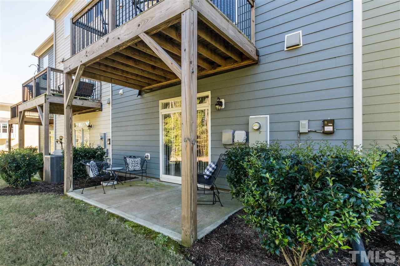 706 Edgewater Ridge Court Apex, NC 27523 - Photo 22 of 25 a view of a patio with table and chairs and potted plants