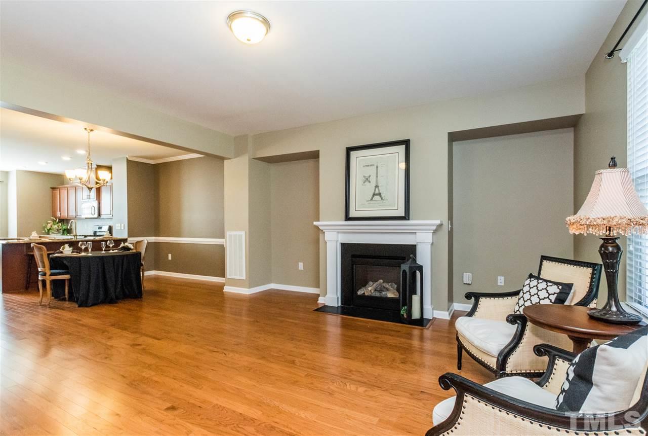 706 Edgewater Ridge Court Apex, NC 27523 - Photo 8 of 25 a living room with furniture and a fireplace