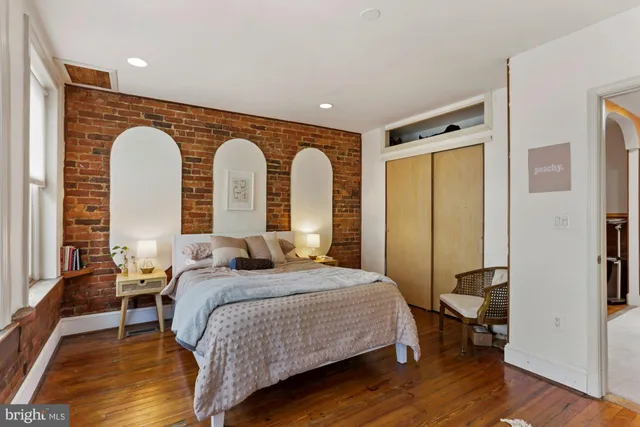 a bedroom with a bed and a large window