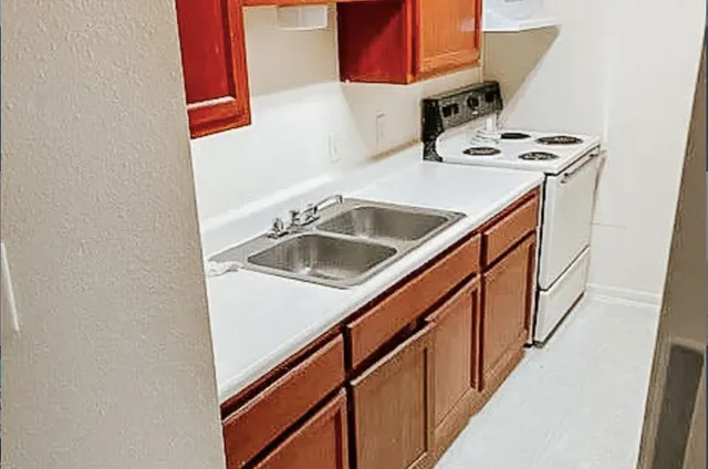 a kitchen that has a sink and a stove