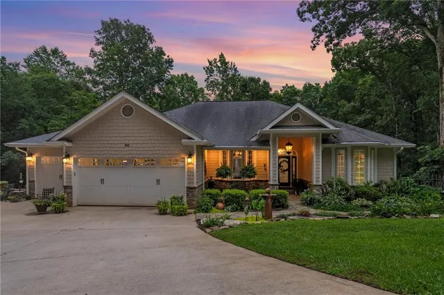 a front view of a house with yard and green space