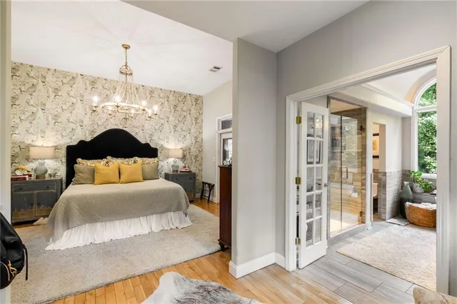 a living room with furniture a fireplace and a chandelier