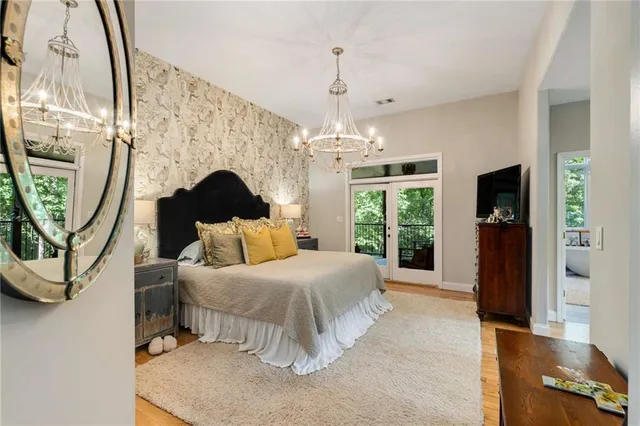 a living room with furniture a fireplace and a chandelier