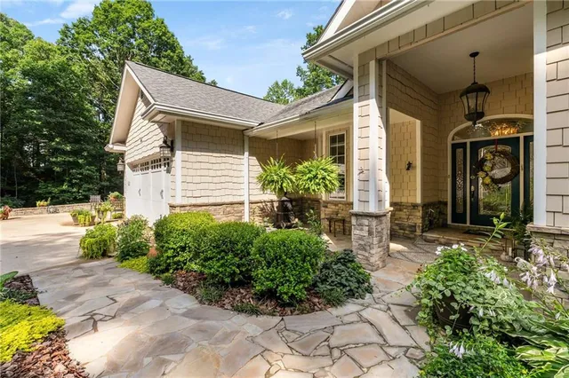 a view of a house with wooden deck and a yard