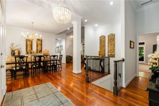 a bedroom with a bed and large windows