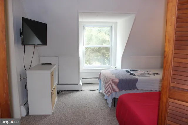 a view of a bedroom with furniture