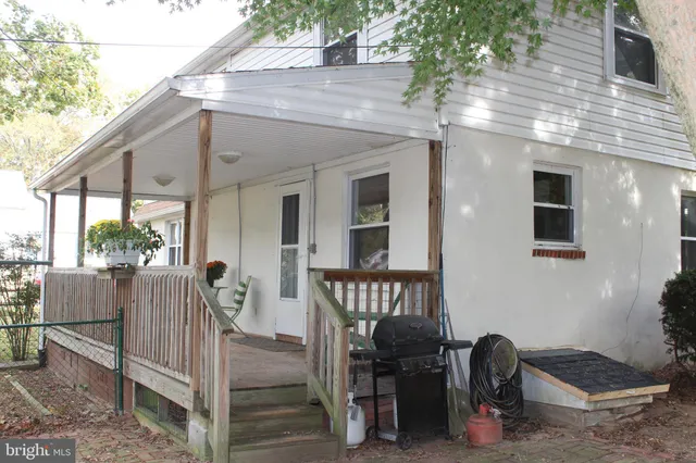 a view of a street with a bench and trees