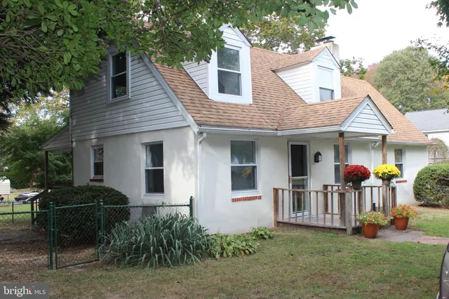 a view of a house with a yard and furniture