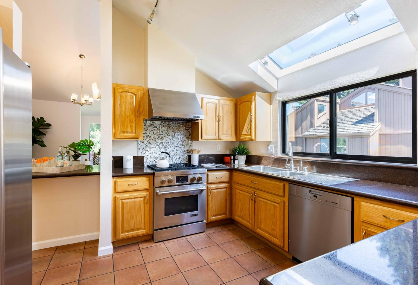 1655 Grant Road Mountain View, CA 94040 - Photo 7 of 24 a kitchen with stainless steel appliances granite countertop stove sink and cabinets