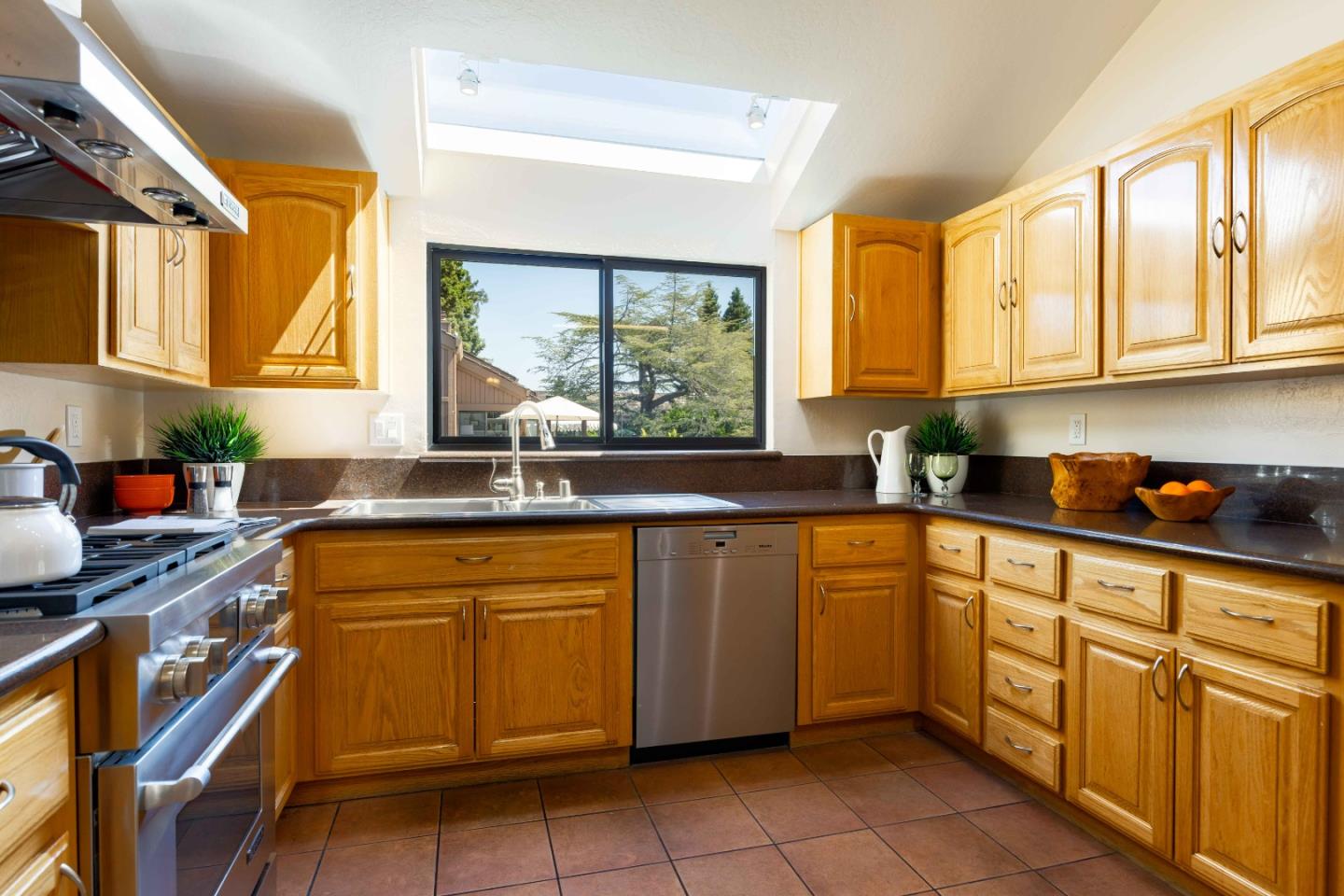 1655 Grant Road Mountain View, CA 94040 - Photo 8 of 24 a kitchen with stainless steel appliances a sink window and cabinets