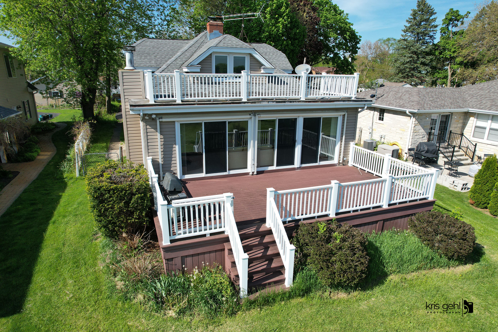 a view of a house with a yard deck and furniture