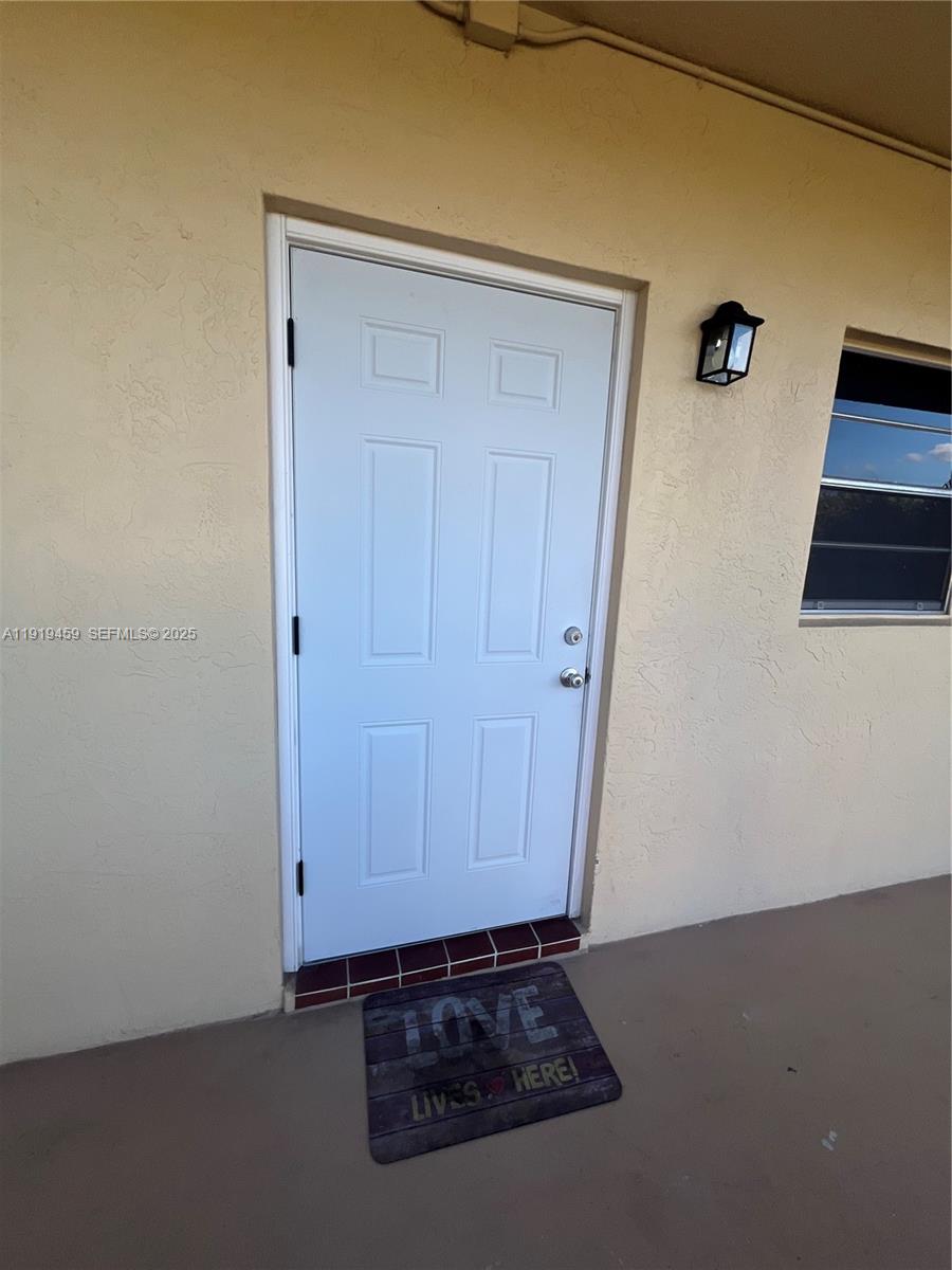 301 Cambridge Road, Unit 211 Hollywood, FL 33024 - Photo 15 of 33 a view of a livingroom with an empty space and wooden floor